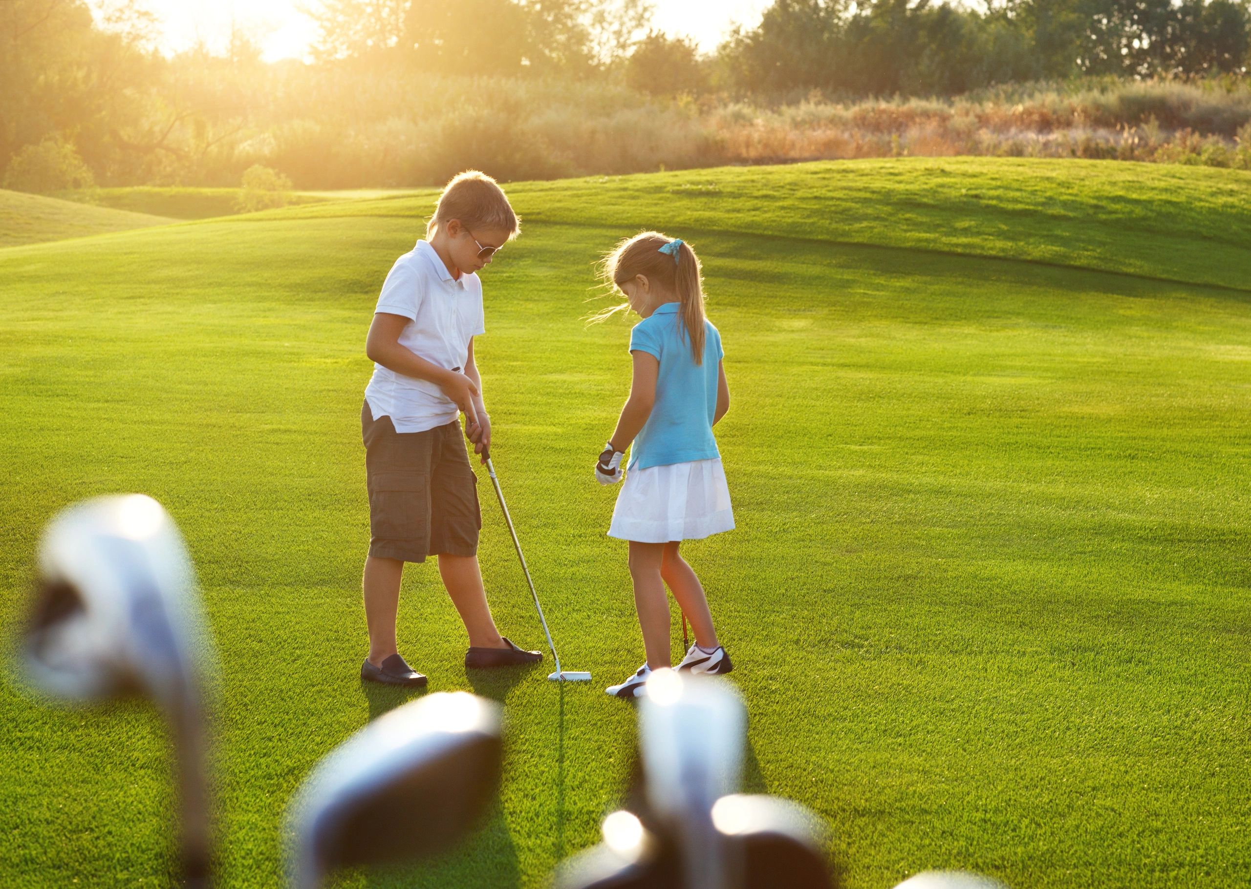 Rear View Of Friends Standing On Golf Course